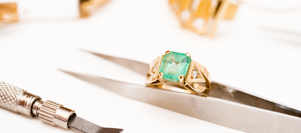 Assorted jeweler tools and gold gem ring